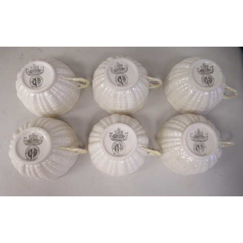 214 - A Belleek Third Period cream coloured lustre glazed, moulded porcelain teaset, comprising six cups, ... 