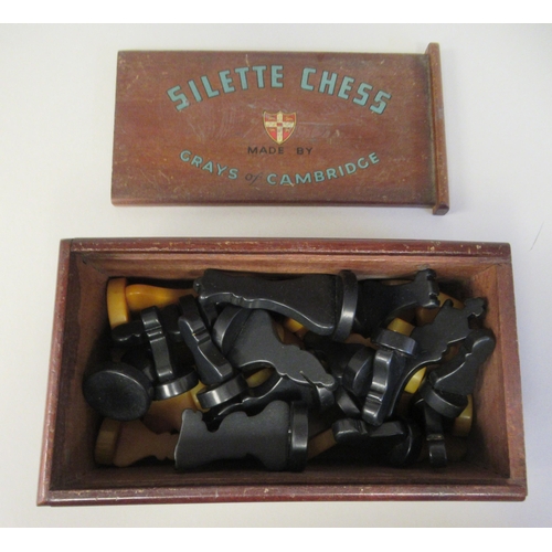 217 - A 1930s Grays of Cambridge Silette chess set, the catalin chessmen in black and 'marbled' yellow, th... 