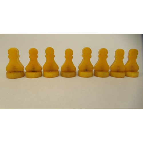 217 - A 1930s Grays of Cambridge Silette chess set, the catalin chessmen in black and 'marbled' yellow, th... 