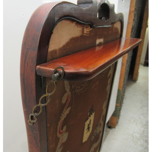 3 - A mid 19thC rosewood firescreen with carved decoration, the glazed and framed panel featuring an emb... 