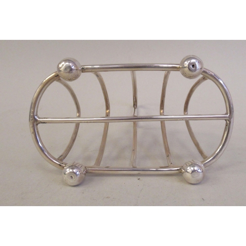 31 - A silver wire four division toastrack, on ball feet  Elkington & Co  Birmingham 1912