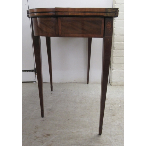 64 - An early 19thC figured mahogany crossbanded satinwood and marquetry tea table, the foldover top over... 