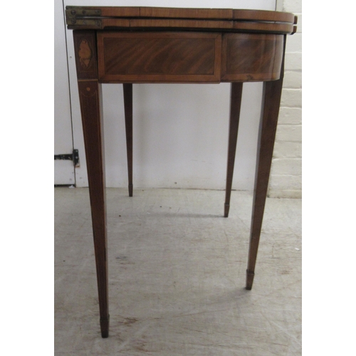 64 - An early 19thC figured mahogany crossbanded satinwood and marquetry tea table, the foldover top over... 