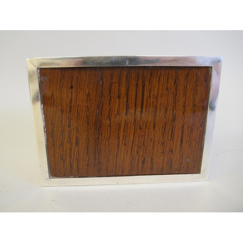 65 - A silver cigarette box with a cedar lining, straight sides and a chamfered, engine turned, hinged li... 