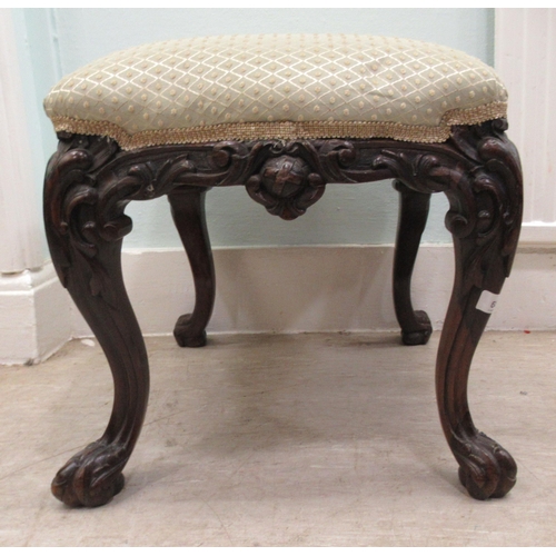 68 - A 19thC dark stained and profusely carved walnut framed stool of serpentine outline, the braided and... 