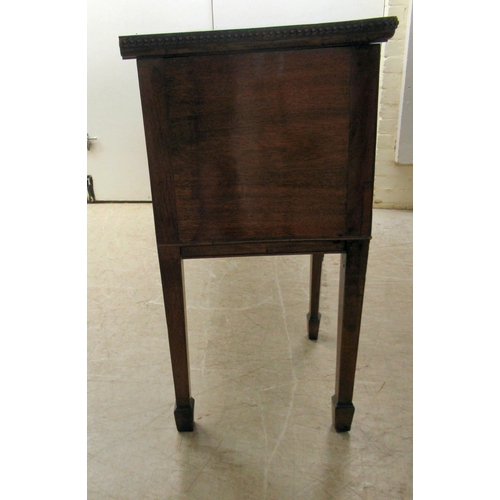 72 - An early 19thC mahogany serpentine front sideboard with carved ornament, comprising a central drawer... 