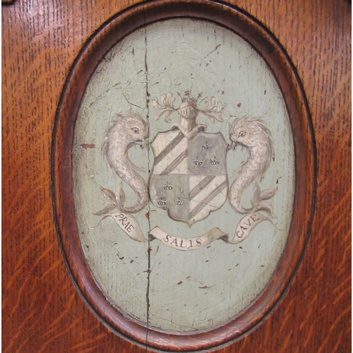 73 - A pair of mid/late 19thC oak framed hall chairs with shield backs, each set with a painted armorial ... 