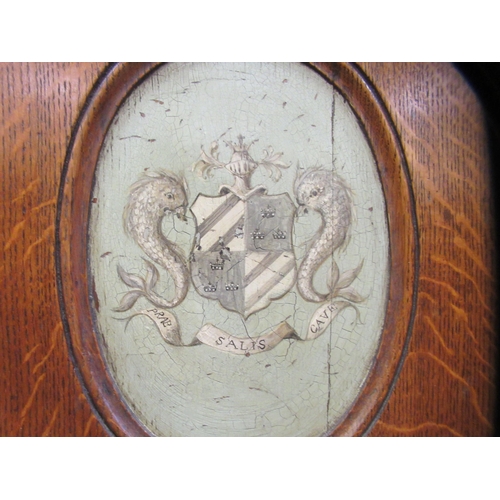 73 - A pair of mid/late 19thC oak framed hall chairs with shield backs, each set with a painted armorial ... 