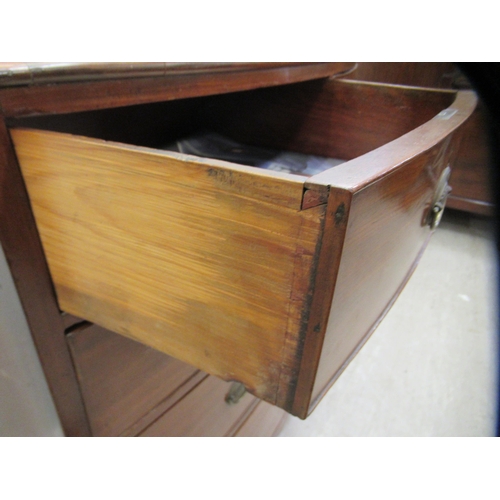 74 - A Victorian mahogany bow front dressing chest with cockbeading and brass bail handles on oval backpl... 