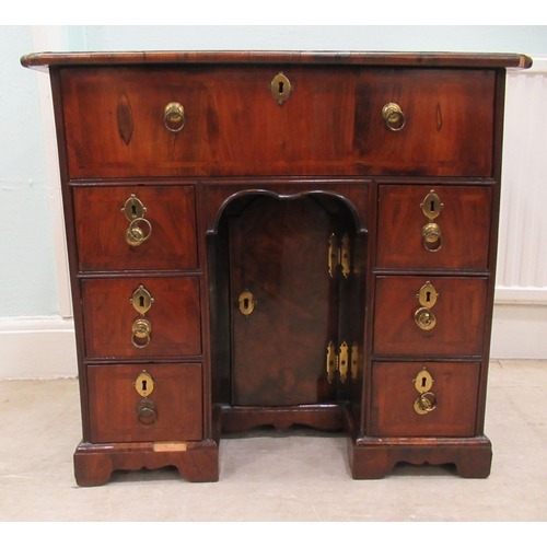 80 - A George III walnut veneered crossbanded and feather inlaid kneehole desk, the top having a cushion ... 