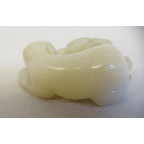 81 - A Chinese jade carved pebble miniature model, a seated animal with it's young