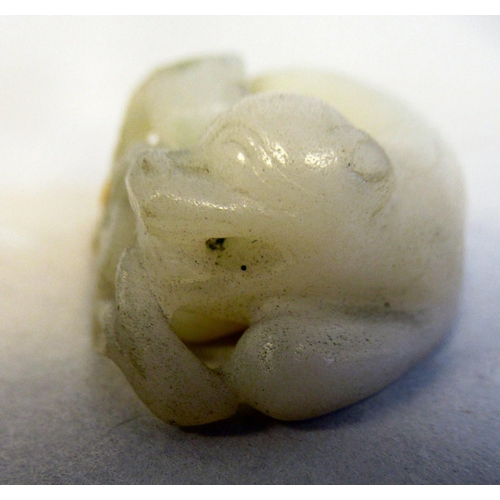 81 - A Chinese jade carved pebble miniature model, a seated animal with it's young