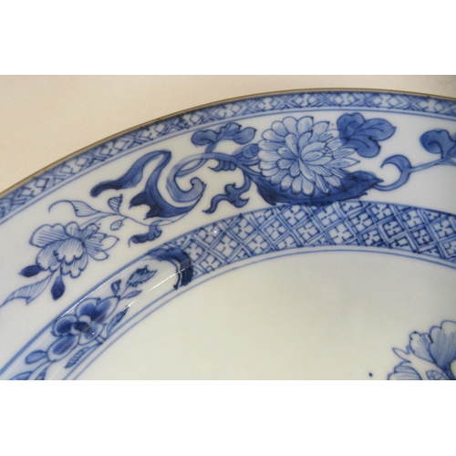 84 - A late 18thC Chinese porcelain charger, decorated in blue and white with flora in a fenced garden&nb... 