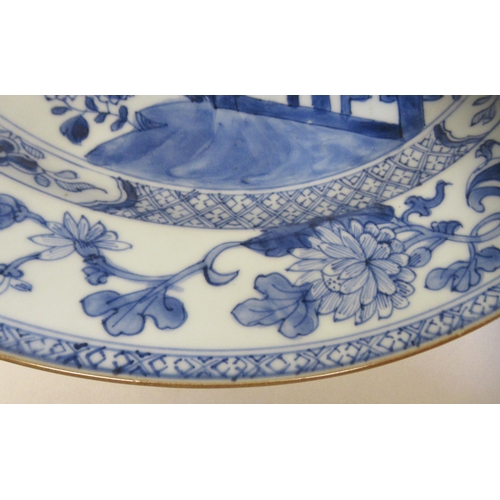 84 - A late 18thC Chinese porcelain charger, decorated in blue and white with flora in a fenced garden&nb... 