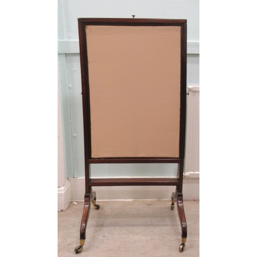 85 - An early 19thC mahogany framed extendable firescreen, the floral fabric covered sliding panels movin... 