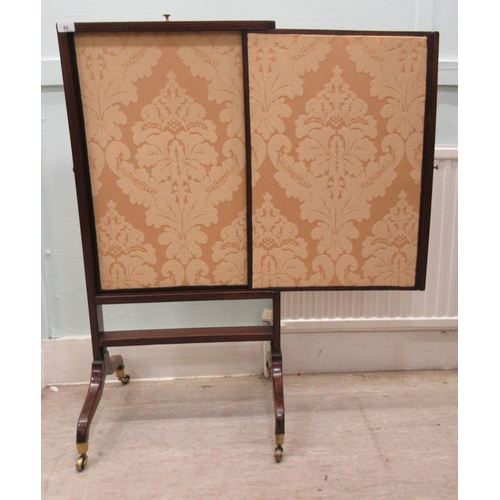 85 - An early 19thC mahogany framed extendable firescreen, the floral fabric covered sliding panels movin... 