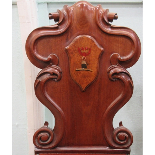 89 - A pair of mid 19thC mahogany hall chairs, the one-piece scroll carved backs with applied and painted... 