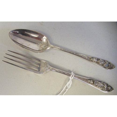 90 - A late Victorian silver Christening spoon and fork, the decoratively engraved stems respectively cas... 