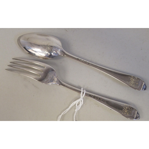 90 - A late Victorian silver Christening spoon and fork, the decoratively engraved stems respectively cas... 