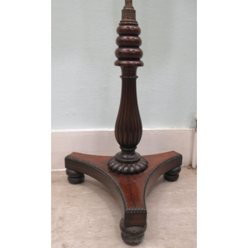 94 - A William IV rosewood polescreen, the height adjustable, scroll carved frame set with a floral crewe... 