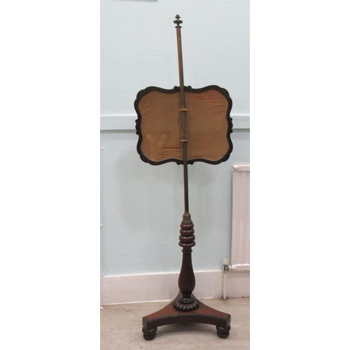 94 - A William IV rosewood polescreen, the height adjustable, scroll carved frame set with a floral crewe... 