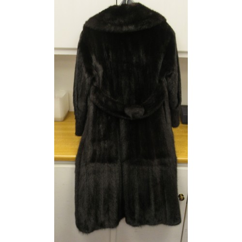 92 - A lady's SAGA knee length, lined, black mink coat with a collar and belt details to the back  approx... 