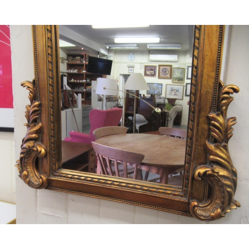 1 - A modern mirror, set in an ornate gilded composition frame  56