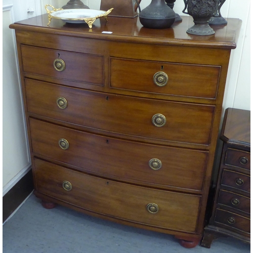 11 - A mid Victorian mahogany bowfront dressing chest with two short/three long drawers, raised on bun fe... 