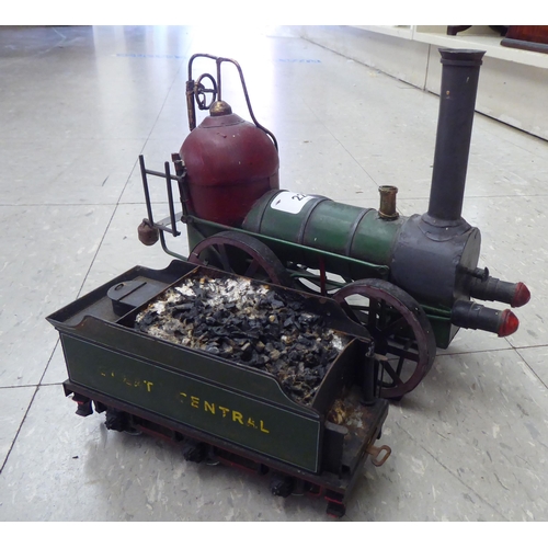 227 - An 0 gauge diecast model railway tender; and painted tinplate model of a steam engine