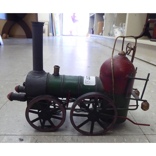 227 - An 0 gauge diecast model railway tender; and painted tinplate model of a steam engine