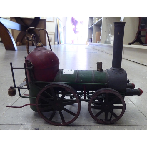 227 - An 0 gauge diecast model railway tender; and painted tinplate model of a steam engine