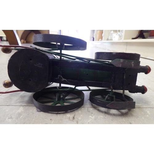 227 - An 0 gauge diecast model railway tender; and painted tinplate model of a steam engine