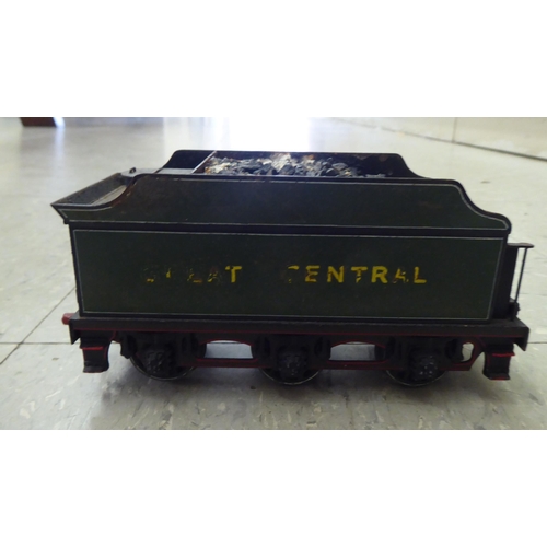 227 - An 0 gauge diecast model railway tender; and painted tinplate model of a steam engine