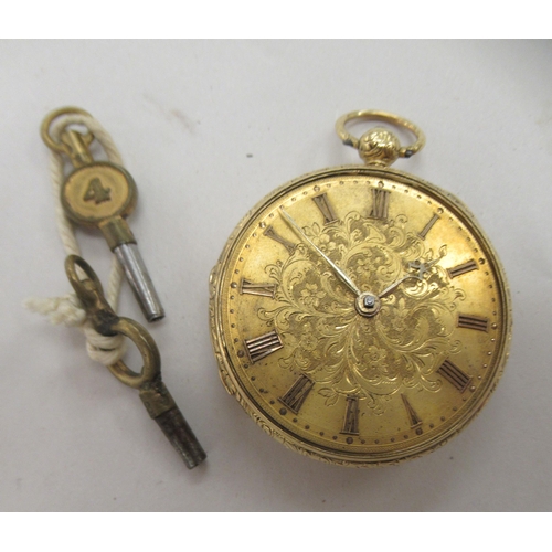 231 - An 18ct gold cased pocket watch with scroll and floral engraved decoration, faced by a decorative gi... 