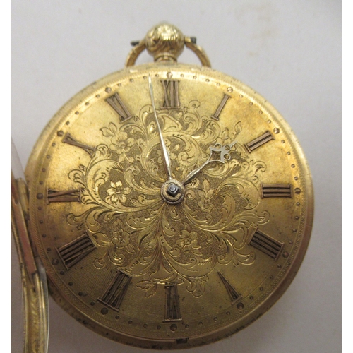 231 - An 18ct gold cased pocket watch with scroll and floral engraved decoration, faced by a decorative gi... 