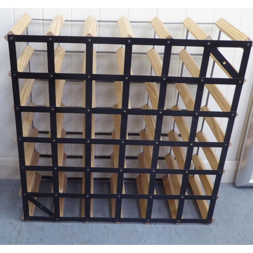 64 - A modern thirty-six hole pine and metal bottle rack  24