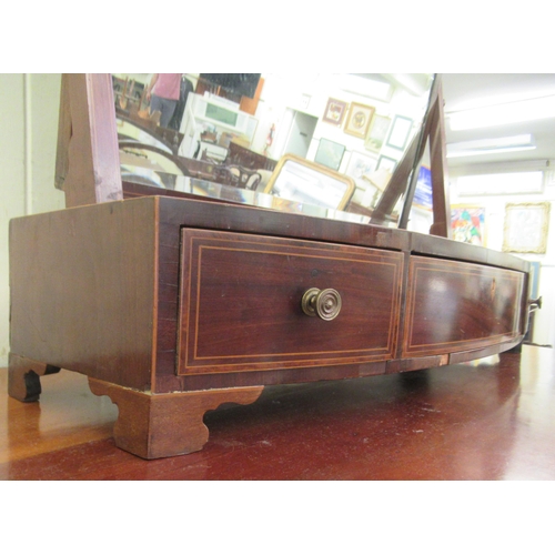 65 - A Regency mahogany framed toilet mirror, on a bow front three drawer box base  29