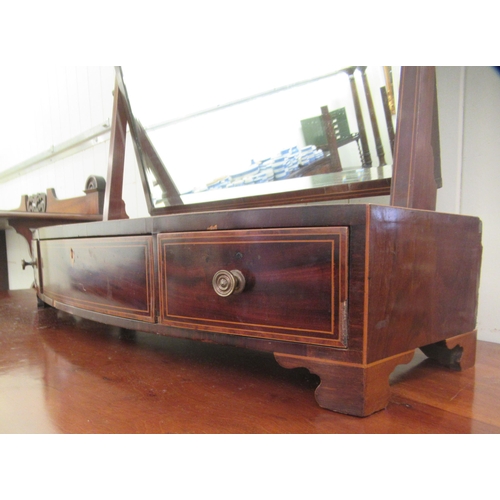 65 - A Regency mahogany framed toilet mirror, on a bow front three drawer box base  29