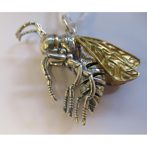 10 - A bi-coloured metal pendant, fashioned as a bee