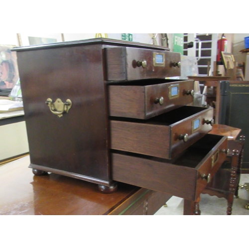 102 - A mid 20thC mahogany four drawer collectors chest, on a plinth and turned bun feet 13.5