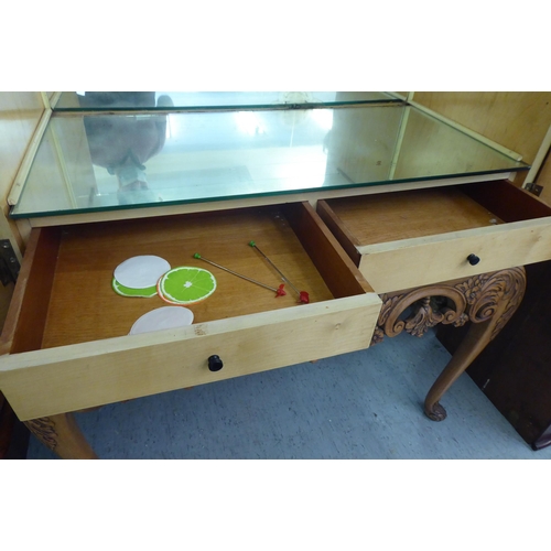 107 - A mid 20thC bleached walnut cocktail cabinet with decoratively pierced and engraved brass mounts, th... 