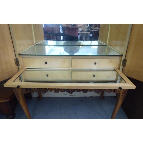 107 - A mid 20thC bleached walnut cocktail cabinet with decoratively pierced and engraved brass mounts, th... 