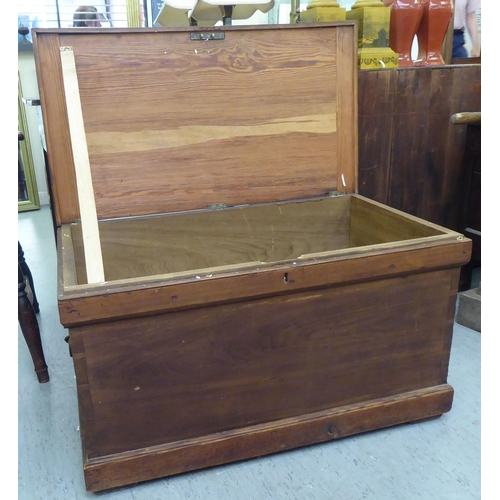 109 - A stained pitch pine box with straight sides, iron flank handles and a hinged lid  20