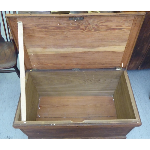 109 - A stained pitch pine box with straight sides, iron flank handles and a hinged lid  20