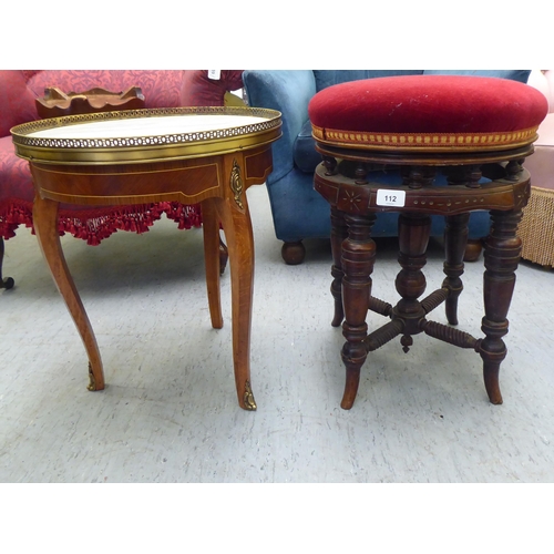 112 - A late Victorian mahogany framed music stool, raised on a multi-ring turned underframe and upholster... 