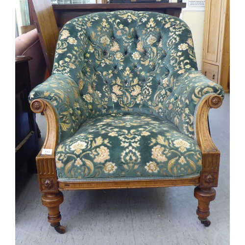 113 - A mid Victorian inlaid and carved walnut, showwood framed tub style salon chair, part button upholst... 