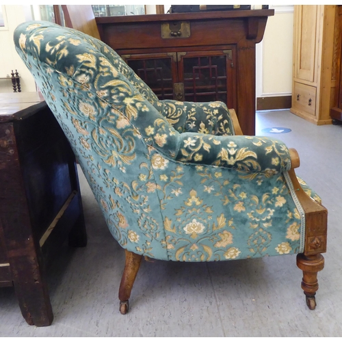 113 - A mid Victorian inlaid and carved walnut, showwood framed tub style salon chair, part button upholst... 