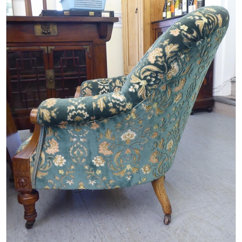 113 - A mid Victorian inlaid and carved walnut, showwood framed tub style salon chair, part button upholst... 