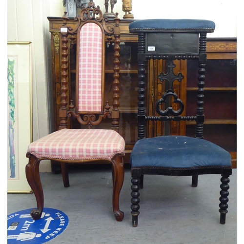 117 - A late Victorian black stained showwood framed prie dieu, upholstered in studded blue dralon and inc... 