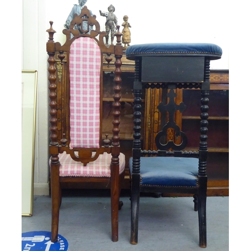 117 - A late Victorian black stained showwood framed prie dieu, upholstered in studded blue dralon and inc... 